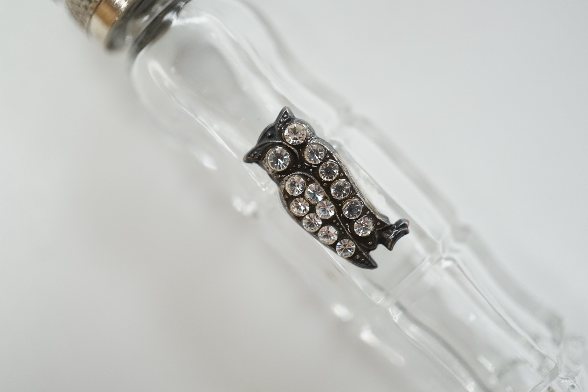 A metal mounted glass scent bottle with paste set owl appliqué, 83mm.